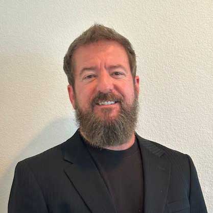 Man in black suit and beard